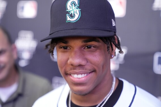 Jurrangelo Cijntje is interviewed after being selected 15th overall by the Seattle Mariners in the first round of the MLB baseball draft in Fort Worth, Texas, Sunday, July 14, 2024. (AP Photo/LM Otero)
