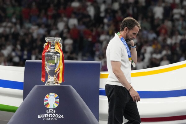 England's manager Gareth Southgate walks past the trophy at the end of the final match between Spain and England at the Euro 2024 soccer tournament in Berlin, Germany, Sunday, July 14, 2024. Spain won 2-1. (AP Photo/Frank Augstein)