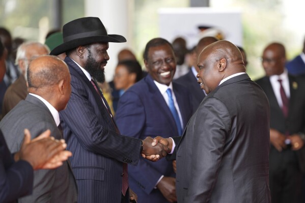 FILE - South Sudanese President Salva Kiir Mayardit, left, shakes hands with Pagan Amum Okiech, leader of the Real-SPLM group, during the launch of high-level peace talks for South Sudan at State House in Nairobi, Kenya, on Thursday, May 9, 2024. South Sudan peace talks that almost reached completion faced a stumbling block with opposition groups demanding a newly passed bill allowing the detention of people without an arrest warrant scratched out in order to sign a proposed agreement. (AP Photo/Brian Inganga, File)