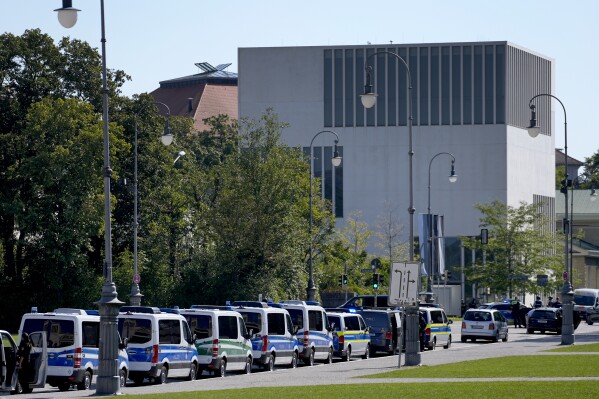 Police cars parked on a street next to the museum on the city's Nazi-era history after police fired shots at a suspicious person near the Israeli Consulate and the museum in Munich, Germany, Thursday, Sept. 5, 2024. (AP Photo/Matthias Schrader)