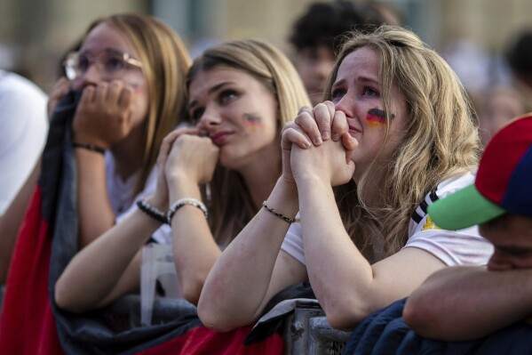 Germany fans react at a fan fest in Stuttgart, Germany, July 5, 2024 during the screening of a quarterfinal match between Germany and Spain at the Euro 2024 soccer tournament in Stuttgart, Germany. (Christoph Schmidt/dpa via AP)