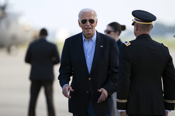 President Joe Biden responds to questions from the traveling press as he arrives at Delaware Air National Guard Base in New Castle, Del., Friday, July 5, 2024, from a campaign rally in Madison, Wis. (AP Photo/Manuel Balce Ceneta)