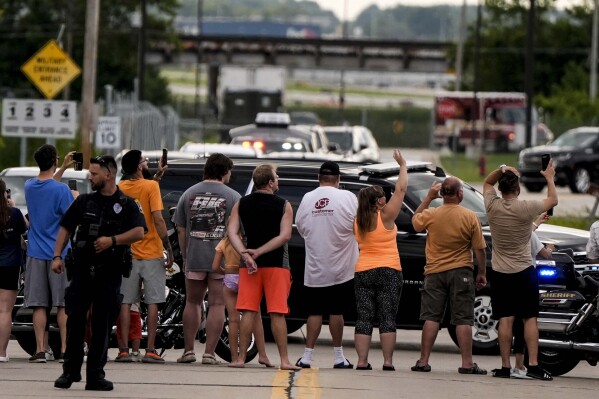 Supporters wave to former President Donald Trump as he arrives to the Milwaukee Mitchell International Airport ahead of the 2024 Republican National Convention, Sunday, July 14, 2024, in Milwaukee. (AP Photo/Mike Stewart)