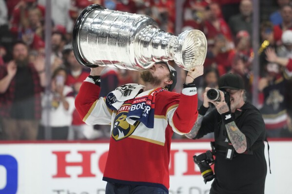 Florida Panthers right wing Vladimir Tarasenko kisses the Stanley Cup trophy after defeating the Edmonton Oilers in Game 7 of the NHL hockey Stanley Cup Final, Monday, June 24, 2024, in Sunrise, Fla. (AP Photo/Wilfredo Lee)