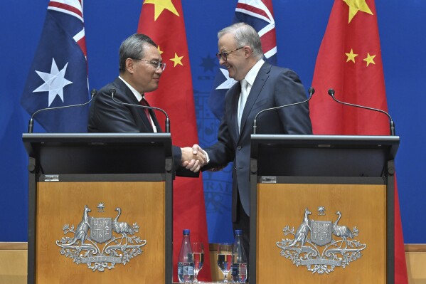 Chinese Premier Li Qiang and Australia's Prime Minister Anthony Albanese shake hands after making opening remarks at Parliament House in Canberra, Monday, June 17, 2024. (Mick Tsikas/Pool Photo via AP)