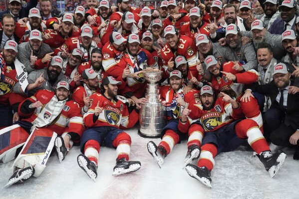 The Florida Panthers team poses with the Stanley Cup trophy after defeating the Edmonton Oilers in Game 7 of the NHL hockey Stanley Cup Final, Monday, June 24, 2024, in Sunrise, Fla. The Panthers defeated the Oilers 2-1. (AP Photo/Wilfredo Lee)