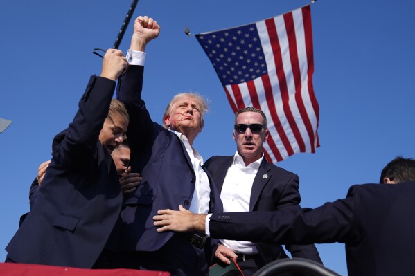 Republican presidential candidate former President Donald Trump is surrounded by U.S. Secret Service agents at a campaign rally, Saturday, July 13, 2024, in Butler, Pa. (AP Photo/Evan Vucci)
