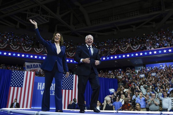 FILE - Democratic presidential nominee Vice President Kamala Harris and her running mate Minnesota Gov. Tim Walz arrive at a campaign rally in Philadelphia, Aug. 6, 2024. (AP Photo/Matt Rourke)