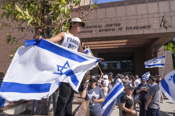 FILE - Eldar Avital, 12, left, joins pro-Israel supporters to condemn a violent protest the previous weekend outside Adas Torah synagogue as members of the Jewish community gather at Simon Wiesenthal Center on June 24, 2024, in Los Angeles. U.S. Attorney General Merrick Garland said Thursday, June 27, 2024, that federal officials are investigating the weekend demonstration by opponents of the Israel-Hamas war in Gaza that spiraled into violence. (AP Photo/Damian Dovarganes, File)