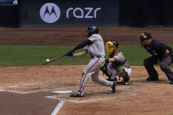 Atlanta Braves' Travis d'Arnaud hits a three-run home run during the sixth inning of a baseball game against the San Diego Padres, Sunday, July 14, 2024, in San Diego. (AP Photo/Gregory Bull)