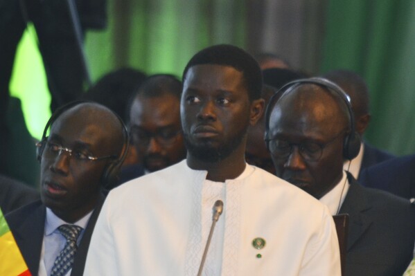 FILE - Senegal's President Basirou Diomaye Faye prior to the start of the ECOWAS meeting, in Abuja, Nigeria, Sunday, July 7, 2024. Senegal’s President Basirou Diomaye Faye is five years younger than West Africa's regional bloc, which he has been tasked to reunite after three of its 15 member states left to form their own union. (AP Photo/Olamikan Gbemiga, File)