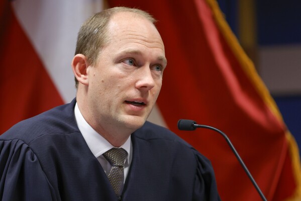 FILE- Fulton County Superior Judge Scott McAfee presides over a hearing is to determine whether Fulton County District Attorney Fani Willis should be removed from the case because of a relationship with Nathan Wade, special prosecutor she hired in the election interference case against former President Donald Trump, Friday, March, 1, 2024, in Atlanta. An attorney for Donald Trump says he’s optimistic an appellate review will lead to the Georgia 2020 election interference case against him being dismissed and Fulton County District Attorney Fani Willis being disqualified. (AP Photo/Alex Slitz, Pool, File)