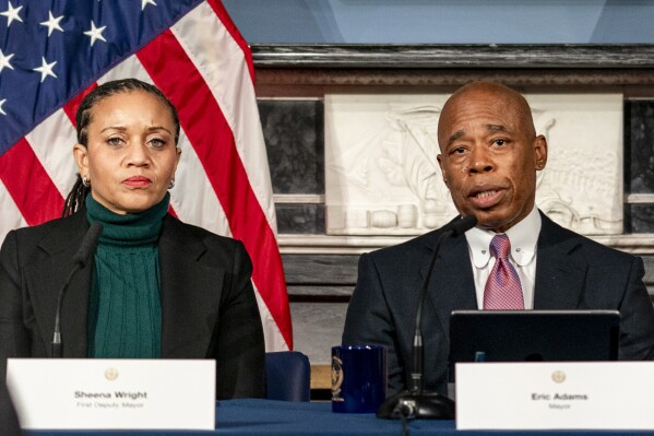 FILE - Mayor Eric Adams, right, is flanked by deputy mayor Sheena Wright, left, during a press conference at City Hall in New York, Dec. 12, 2023. (AP Photo/Peter K. Afriyie, File)