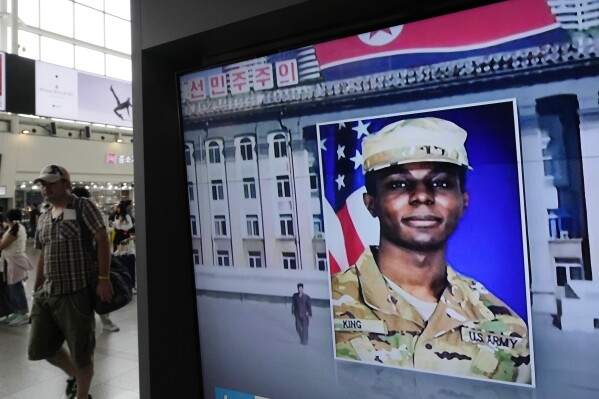 FILE - A television screen shows a file image of Pvt. Travis King during a news program at the Seoul Railway Station in Seoul, South Korea Aug. 16, 2023. King, who fled to North Korea just over a year ago, will plead guilty to desertion and four other charges and take responsibility for his conduct. (AP Photo/Ahn Young-joon, File)