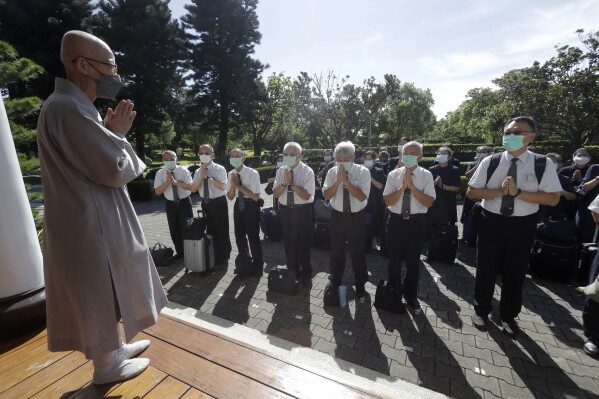 Tzu Chi volunteers say goodbye to a Buddhist master before setting out on a volunteer mission at the Jing Si Abode in Hualien, Taiwan, Thursday, July 6, 2023. (AP Photo/Chiang Ying-ying)