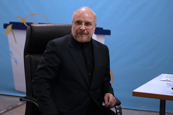 Iran's hard-line parliament speaker Mohammad Bagher Qalibaf sits while registering his name as a candidate for the June 28 presidential election at the Interior Ministry, in Tehran, Iran, Monday, June 3, 2024. Iran's Guardian Council on Sunday, June, 9, approved the country's hard-line parliament speaker and five others to run in the country's presidential election following a helicopter crash that killed President Ebrahim Raisi and seven others. (AP Photo/Vahid Salemi)