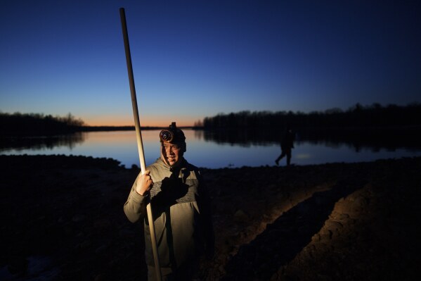John Baker holds a spear while getting ready for a night of fishing at the Chippewa Flowage on the Lac Courte Oreilles Reservation, Sunday, April 14, 2024, near Hayward, Wis. Spearfishing is a traditional Ojibwe method of harvesting fish such as walleye in the spring when the fish venture to shallow waters in the evening to spawn. (AP Photo/John Locher)