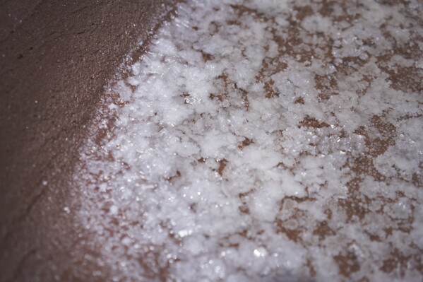 Salt begins to form in one of the dozens of salt beds in the Hanapepe salt patch on Kauai Island on Wednesday, July 12, 2023, in Hanapepe, Hawaii. This Native Hawaiian salt has been hand made for generations. And as a part of the culture and spiritual practice, it has always been given away or traded, but never sold. (AP Photo/Jessie Wardarski)