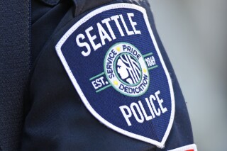 FILE - A Seattle Police Department patch is seen on an officer's uniform, July 17, 2016, in Seattle. The Washington Supreme Court heard arguments Tuesday, June 25, 2024 in a case that will decide whether the names of four Seattle police officers who attended events in the nation’s capital on the day of the insurrection are protected under the state's public records law. (AP Photo/Ted S. Warren, File)