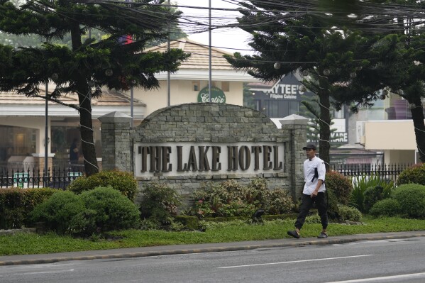 A man walks outside the Lake Hotel in Tagaytay city, south of Manila, Philippines on Thursday, July 11, 2024. Two Australian nationals and a Filipina companion were killed at the Lake Hotel and police efforts were underway to identify and track down suspects, officials said. (AP Photo/Aaron Favila)