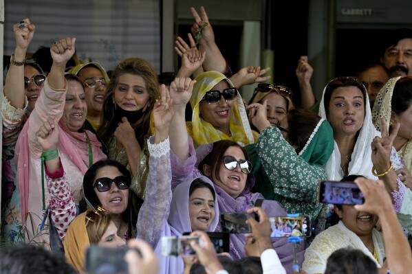 Supporters of imprisoned former Prime Minister Imran Khan's party Tehreek-e-Insaf, react after a Supreme Court decision in a case of reserved seats for women and minorities in the parliament, in Islamabad, Pakistan, Friday, July 12, 2024. Pakistan's top court on Friday ruled that the party of imprisoned former Prime Minister Khan is eligible for seats reserved in the parliament, a major blow to the country's weak coalition government. (AP Photo/Anjum Naveed)