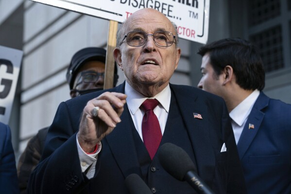 FILE - Rudy Giuliani speaks during a news conference outside federal court in Washington, Dec. 15, 2023. On Friday, July 12, 2024, a federal judge threw out the bankruptcy case of the former New York mayor, citing repeated “uncooperative conduct,” including a failure to comply with court orders and disclose sources of income. (AP Photo/Jose Luis Magana, File)