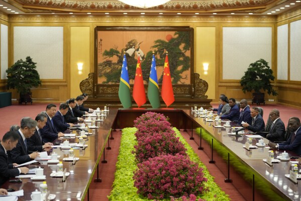 Solomon Islands Prime Minister Jeremiah Manele, second right, attends a meeting with Chinese President Xi Jinping, fourth left, at the Great Hall of the People in Beijing, China, Friday, July 12, 2024. (AP Photo/Vincent Thian, Pool)