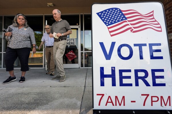 FILE - Voters depart an election center during primary voting, May 21, 2024, in Kennesaw, Ga. Conservative groups are systematically attempting to challenge large numbers of voter registrations across the country ahead of this year's presidential election. The strategy is part of a wider effort to raise questions about the integrity of this year's election as former President Donald Trump repeatedly claims without evidence that his opponents are trying to cheat. (AP Photo/Mike Stewart, File)