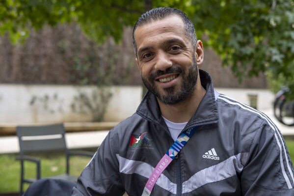 Palestinian athlete Fadi Aldeeb poses for a photograph outside the athletes' village at the Paralympic Games in Paris, Tuesday, Sept. 3, 2024. (AP Photo/Ciaran Fahey)