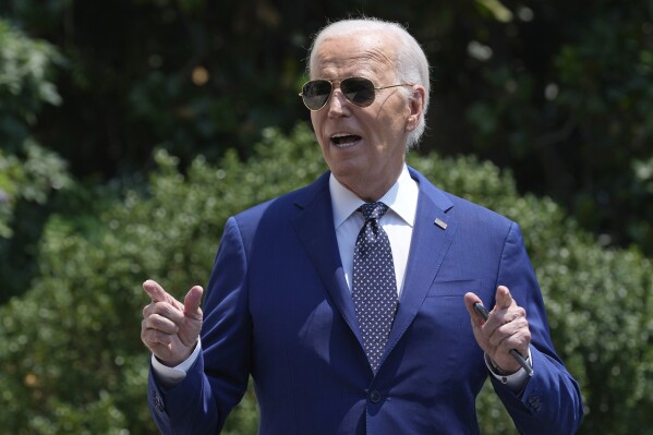 President Joe Biden briefly talks with reporters as he heads to Marine One on the South Lawn of the White House in Washington, July 29, 2024. (AP Photo/Susan Walsh)