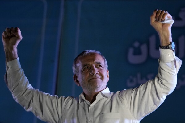 Reformist candidate for the Iran's presidential election Masoud Pezeshkian clenches his fists during a campaign rally in Tehran, Iran, Wednesday, July 3, 2024. (AP Photo/Vahid Salemi)