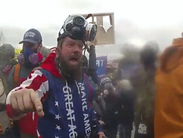 In this image from U.S. Capitol Police video, released and annotated by the Justice Department in the sentencing memorandum, Christopher Quaglin, appears on police body-worn camera footage at the U.S. Capitol on Jan. 6, 2021, in Washington. Quaglin, a New Jersey electrician who repeatedly attacked police officers during the siege at the U.S. Capitol has been sentenced to 12 years in prison. (Justice Department via AP)