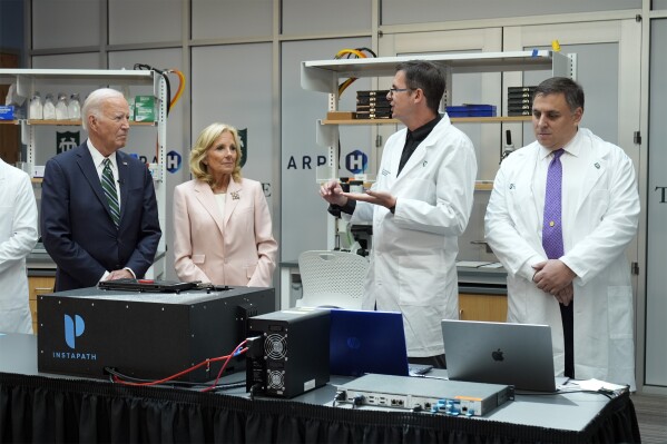 President Joe Biden and first lady Jill Biden listen during a demonstration of cancer research and detection techniques at Tulane University, Tuesday, Aug. 13, 2024, in New Orleans. (AP Photo/Mark Schiefelbein)