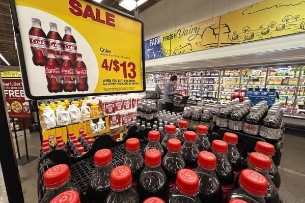 A customer passes an array of beverages while shopping at a grocery store in Chicago, Thursday, Sept. 19, 2024. (AP Photo/Nam Y. Huh)