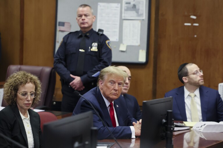 Former President Donald Trump appears during a court hearing at Manhattan criminal court, Thursday, Feb. 15, 2024, in New York. A New York judge says Trump's hush-money trial will go ahead as scheduled with jury selection starting on March 25. (Brendan McDermid/Pool Photo via AP)