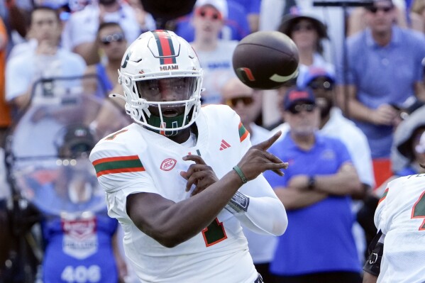 Miami quarterback Cam Ward throws a pass during the first half of an NCAA college football game against Florida, Saturday, Aug. 31, 2024, in Gainesville, Fla. (AP Photo/John Raoux)