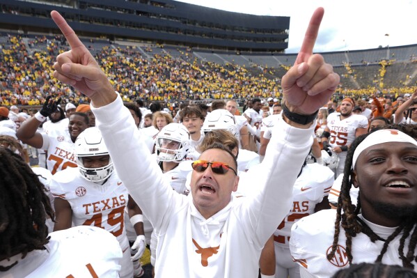 Texas head coach Steve Sarkisian celebrates after in beating Michigan 31-12 in an NCAA college football game in Ann Arbor, Mich., Saturday, Sept. 7, 2024. (AP Photo/Paul Sancya)