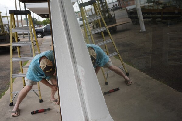 Jimmy May boards windows as he prepares for Hurricane Beryl's arrival, Sunday, July 7, 2024, in Port Lavaca, Texas. (AP Photo/Eric Gay)