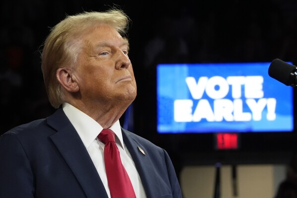 With "Vote Early" displayed on a screen behind, Republican presidential nominee former President Donald Trump speaks at a campaign rally at the Santander Arena, Wednesday, Oct. 9, 2024, in Reading, Pa. (AP Photo/Alex Brandon)