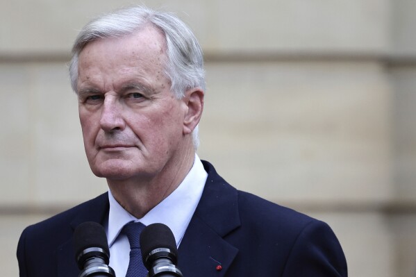 New French prime minister Michel Barnier looks on right during the handover ceremony, Thursday, Sept. 5, 2024 in Paris. President Emmanuel Macron has named EU's Brexit negotiator Michel Barnier as France's new prime minister after more than 50 days of caretaker government. (Stephane de Sakutin/Pool Photo via AP)