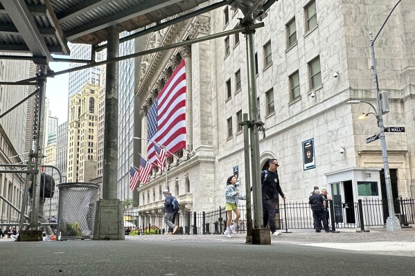 The American flag hangs from the front of the New York Stock Exchange on Wednesday, Sept. 11, 2024, in New York. (AP Photo/Peter Morgan)