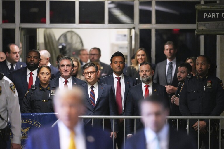 From left North Dakota Gov. Doug Burgum, U.S. Speaker of the House Mike Johnson and businessman Vivek Ramaswamy look on as former President Donald Trump talks to the media as he arrives at Manhattan criminal court in New York, on May 14, 2024. (Curtis Means/Pool Photo via AP)