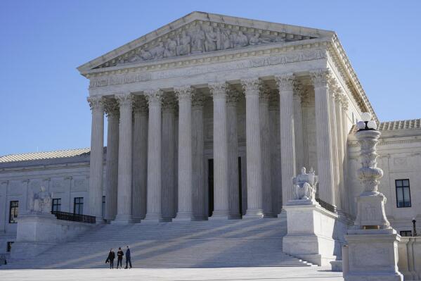 FILE - Visitors walk outside the Supreme Court building on Capitol Hill in Washington, Feb. 21, 2022.  (AP Photo/Patrick Semansky, File)