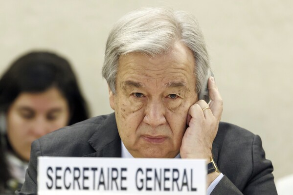 FILE - U.N. Secretary-General Antonio Guterres listens to a speech during the opening of the High-Level Segment of the 55th session of the Human Rights Council at the European headquarters of the United Nations in Geneva, Switzerland, on Feb. 26, 2024. Guterres appealed for funding Friday, July 12, 2024, for the beleaguered U.N. agency helping Palestinian refugees in Gaza and elsewhere in the Middle East, accusing Israel of issuing evacuation orders that force Palestinians “to move like human pinballs across a landscape of destruction and death.”(Salvatore Di Nolfi/Keystone via AP, File)