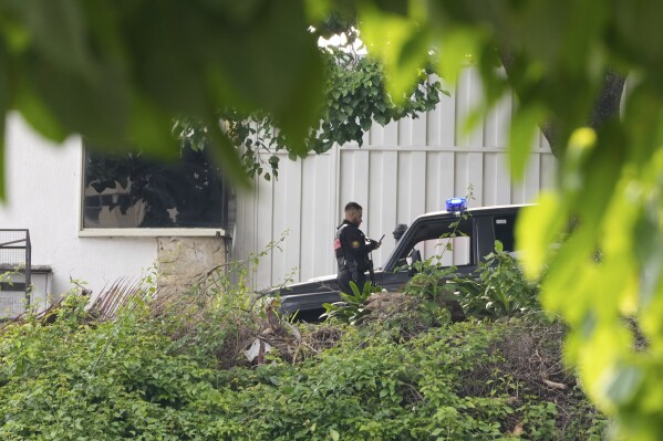 Police guard Argentina's embassy in Caracas, Venezuela, Saturday, Sept. 7, 2024. (AP Photo/Ariana Cubillos)