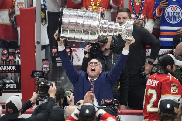Florida Panthers head coach Paul Maurice lifts the Stanley Cup trophy after Game 7 of the NHL hockey Stanley Cup Final against the Edmonton Oilers, Monday, June 24, 2024, in Sunrise, Fla. The Panthers defeated the Oilers 2-1 (AP Photo/Rebecca Blackwell)