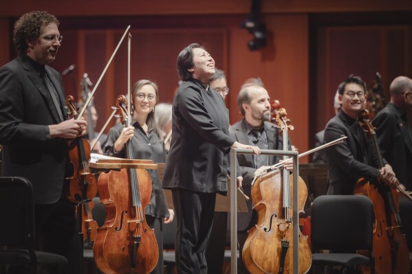 Xian Zhang, center, appears during a pre-concert performance at Benaroya Hall in Seattle on April 4, 2024. (Carlin Ma via AP)