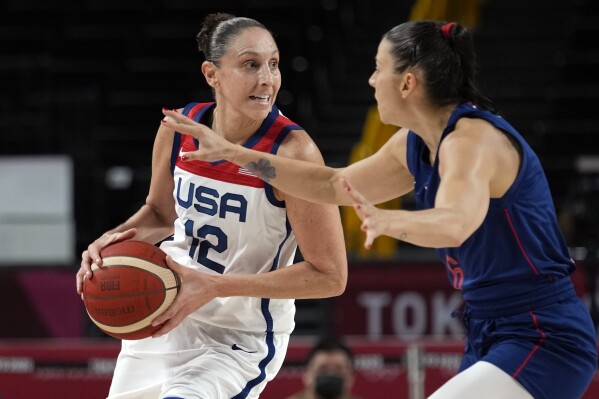 FILE - United States' Diana Taurasi (12) drives around Serbia's Sasa Cado (6) during women's basketball semifinal game at the 2020 Summer Olympics, Friday, Aug. 6, 2021, in Saitama, Japan. The U.S. women's basketball team is on a historic run, winning seven straight Olympic gold medals. (AP Photo/Eric Gay, File)