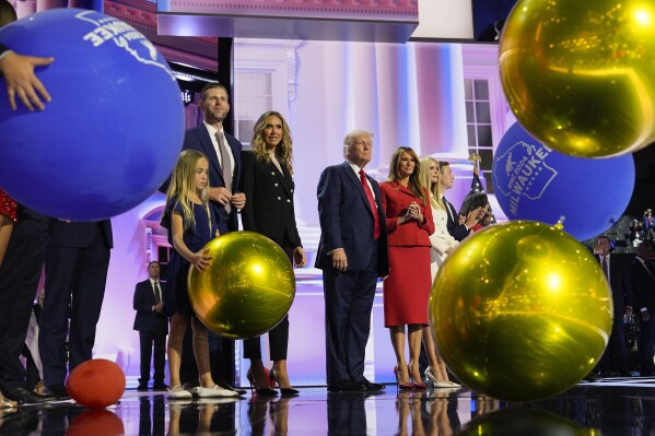 Republican presidential candidate former President Donald Trump, center, stands on stage with Melania Trump and other members of his family during the Republican National Convention, Thursday, July 18, 2024, in Milwaukee. (AP Photo/Julia Nikhinson)