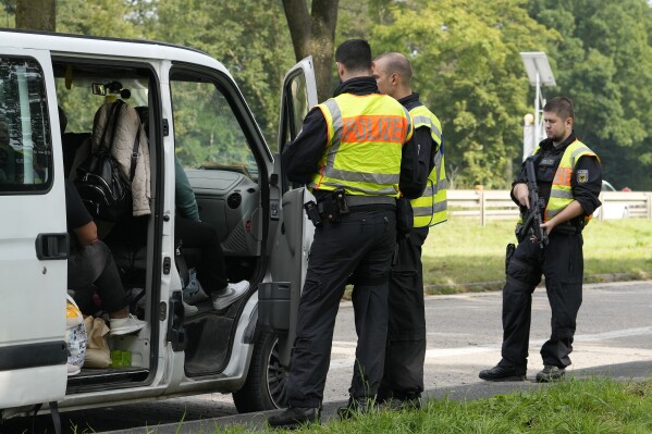 German police check the details of a van from Bulgaria near the border to Belgium in Aachen, Germany, Monday, Sept. 16, 2024, as Germany begins carrying out checks at all its land borders. (AP Photo/Martin Meissner)